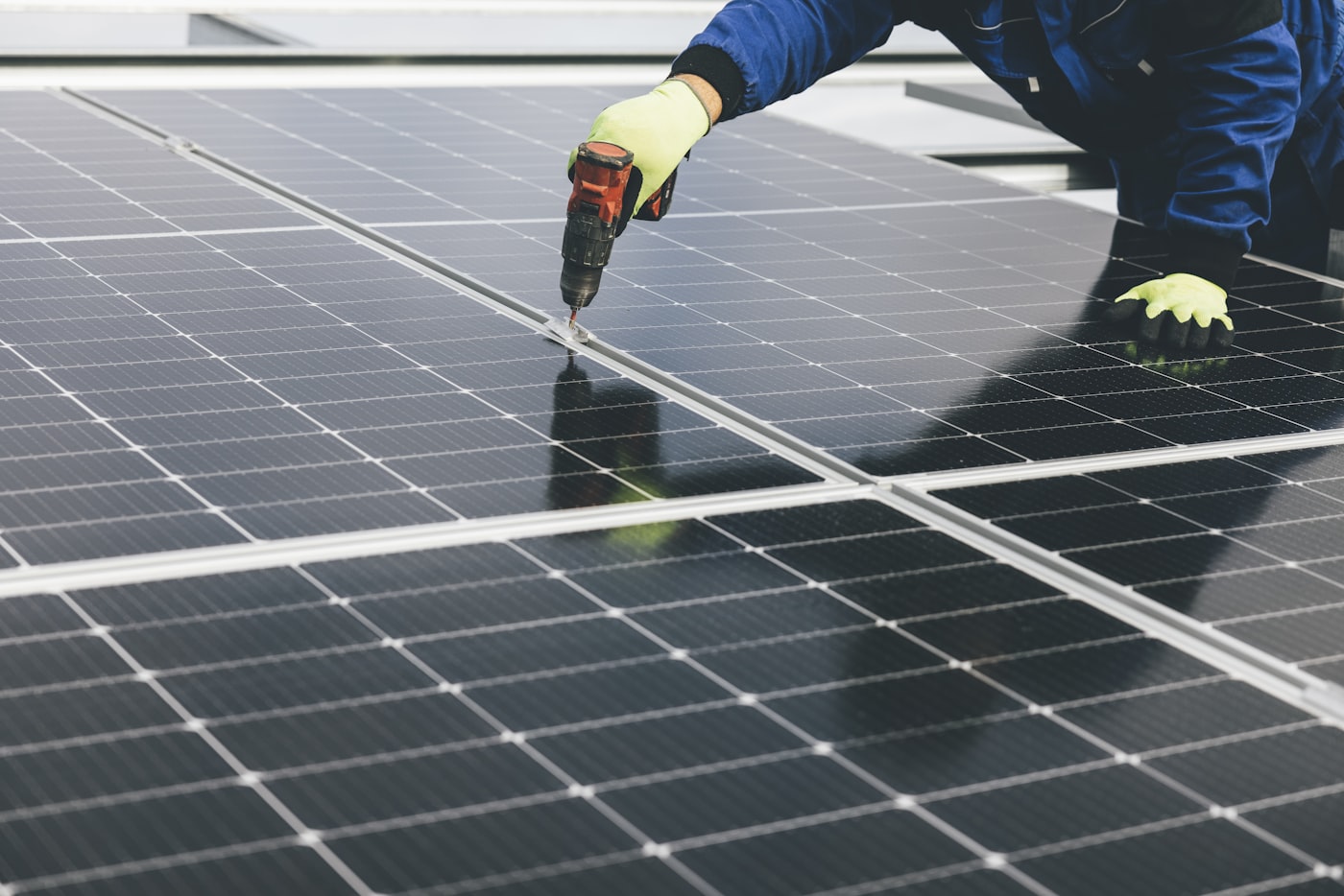 Zephira technician mounting a solar panel with a power tool