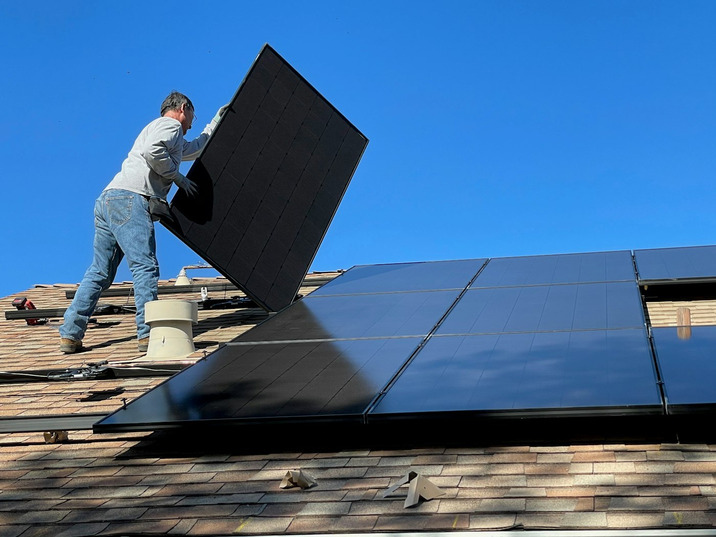 Zephira technician installing a rooftop solar panel